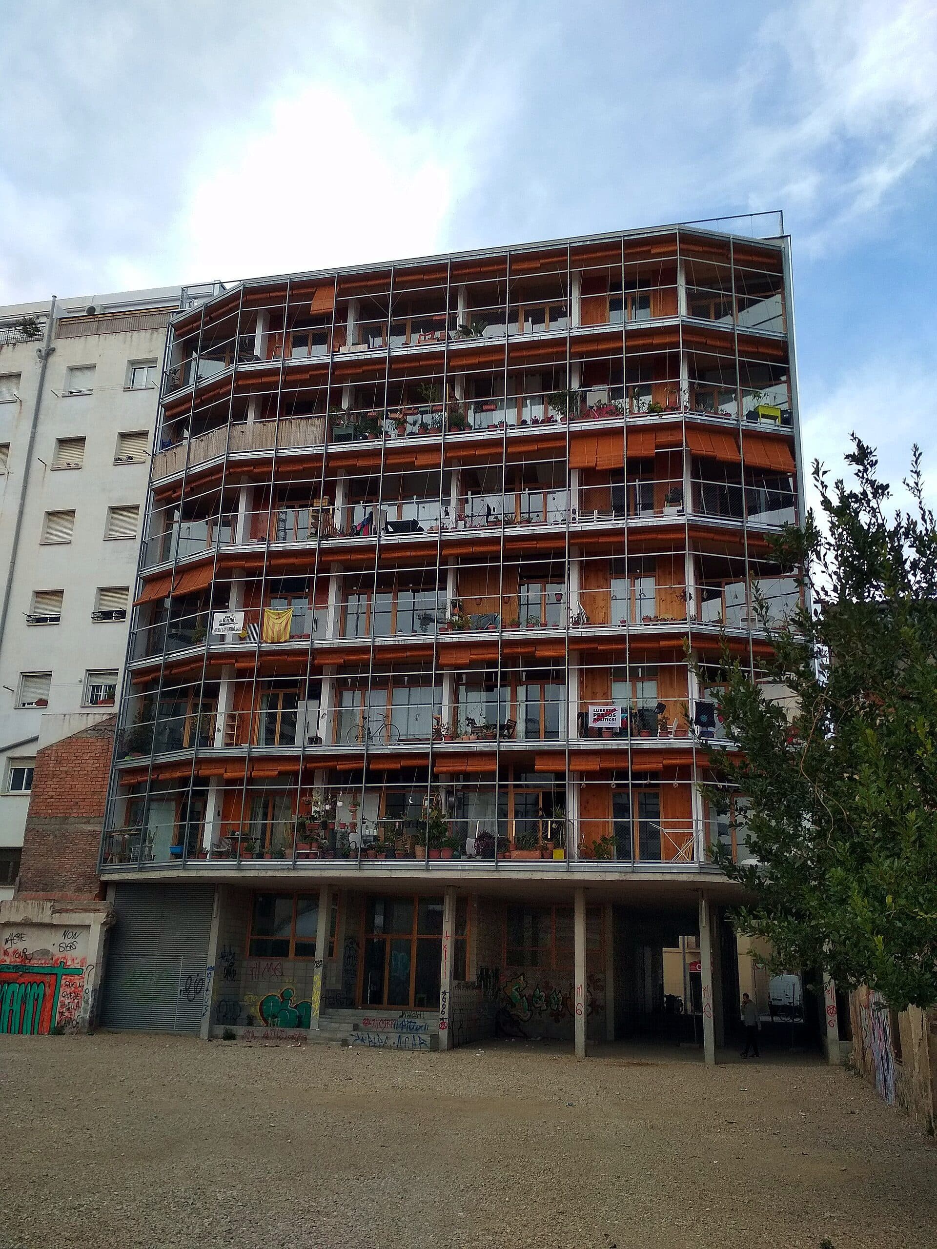 The timber-framed rear facade of La Borda, a resident-led housing cooperative in Barcelona